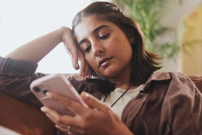 A woman stressing over a message she just received.