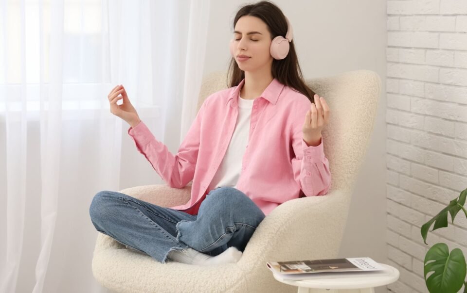 how to make meditation easier at home. A woman in a chair meditating