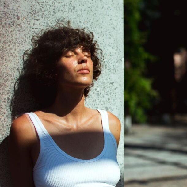 Woman standing in the sun feeling lost after achieving a goal