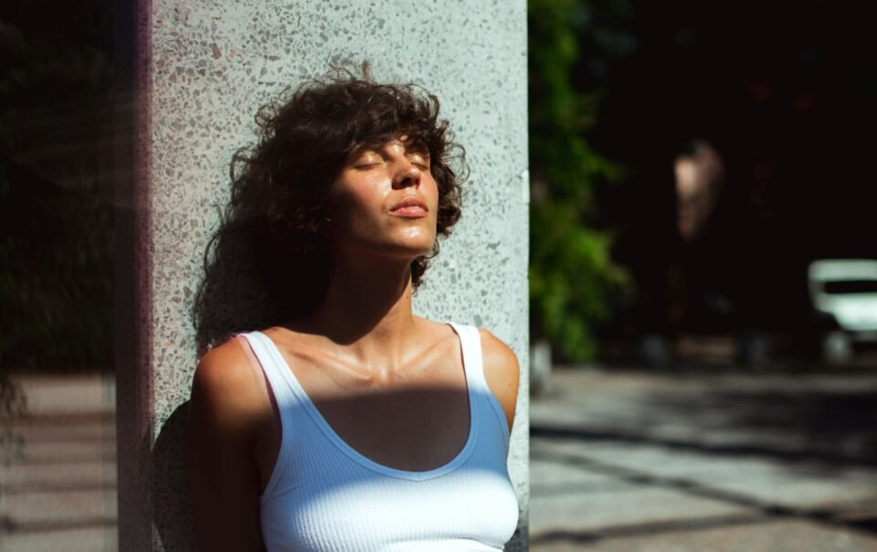 Woman standing in the sun feeling lost after achieving a goal