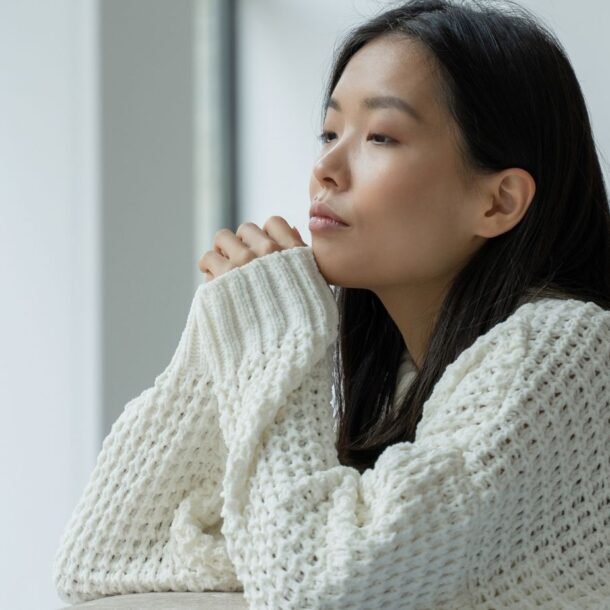 Person sitting quietly in natural light learning how to be more aware of your thoughts