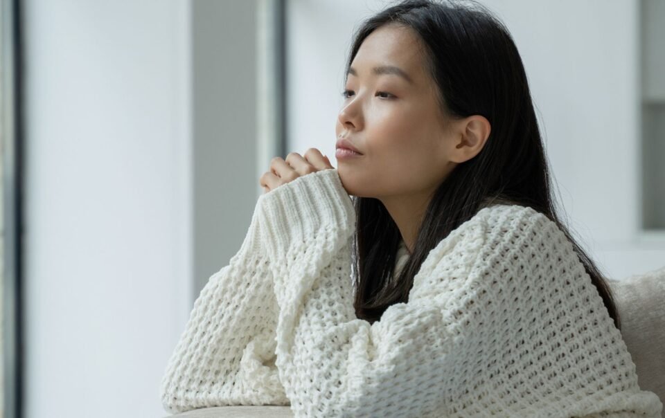 Person sitting quietly in natural light learning how to be more aware of your thoughts