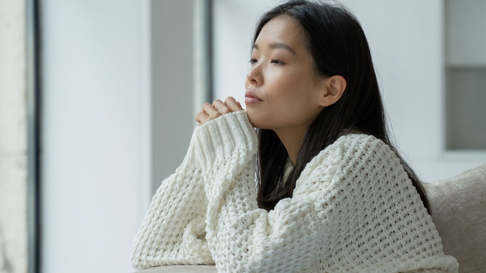 Person sitting quietly in natural light learning how to be more aware of your thoughts