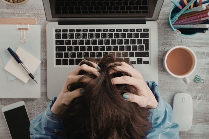 Person sitting in front of laptop struggling with avoidance behavior