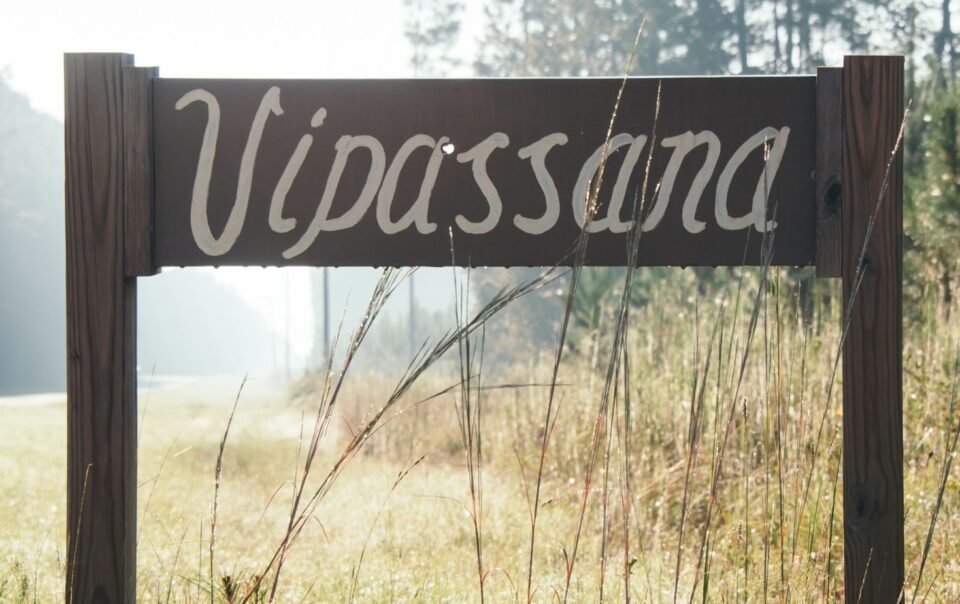 Vipassana retreat sign with a bullet hole above the a.