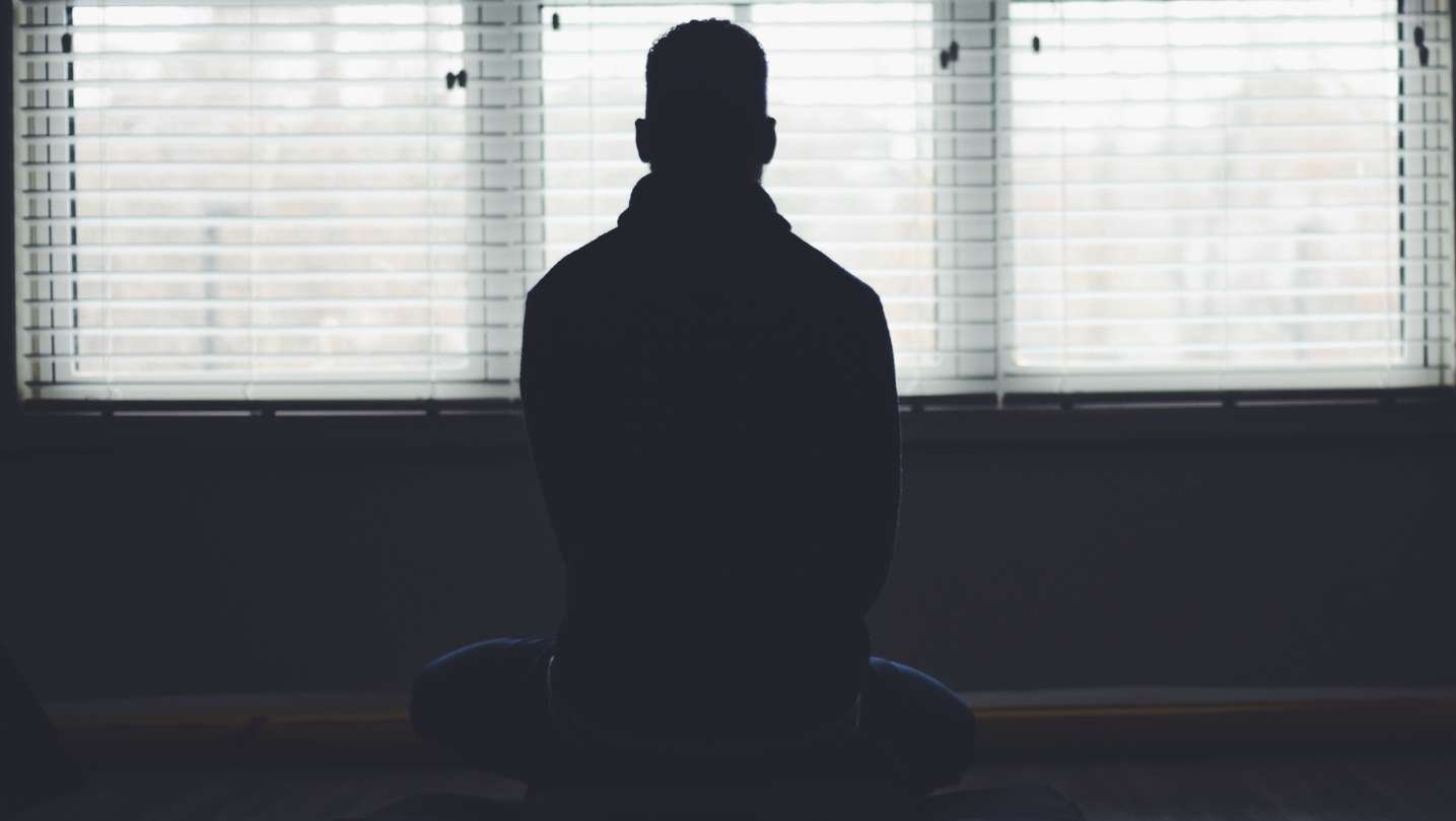 Klaye sitting in meditation practicing mindfulness and intentional living