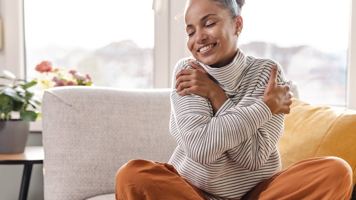 A woman loving herself after dealing with a lot of negative self talk.